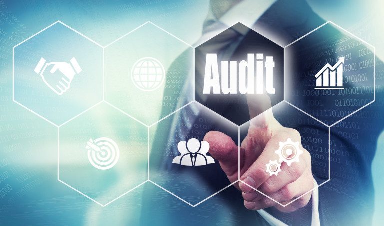 man pointing at audit button